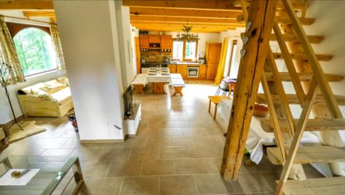 a living room with a staircase in a house at Chata Paradise in Smižany