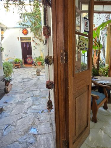 an open door to a patio with a stone floor at Holistic Scandinavia House in Arequipa