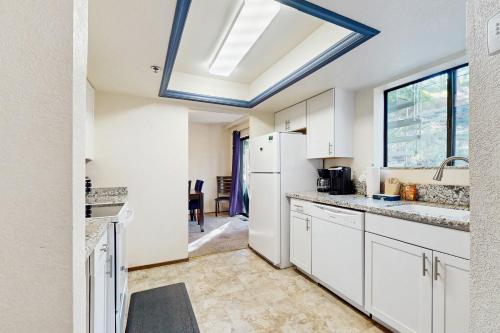 a kitchen with white cabinets and a skylight at South Star Pines Retreat in Stateline