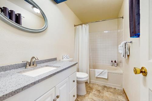 a bathroom with a sink and a toilet and a mirror at South Star Pines Retreat in Stateline