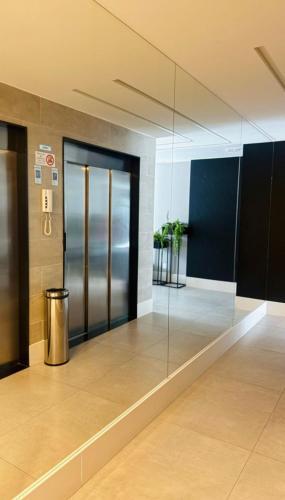a lobby with glass doors in a building at Estúdio 1009 - Jardim Camburi, Vitória - ES in Vitória