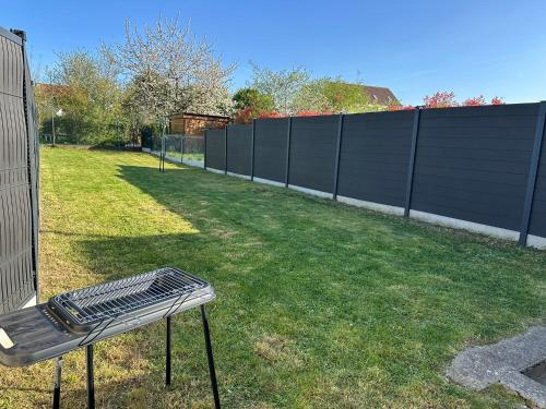 a bench sitting in a yard next to a fence at Le Soixante Dix Sept in Arras