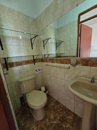 a bathroom with a toilet and a sink at Holistic Scandinavia House in Arequipa
