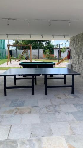a ping pong table sitting on top of a floor at Malia Beach Porto Galinha By Loui in Ipojuca