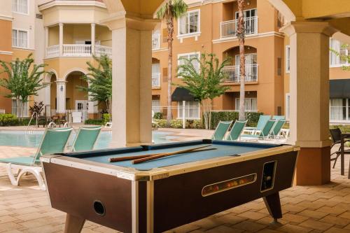 a pool table in the courtyard of a building at The Point Universal by Edge near Epic in Orlando