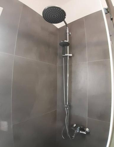 a shower with a shower head in a bathroom at Bridge House Corfu in Potamós