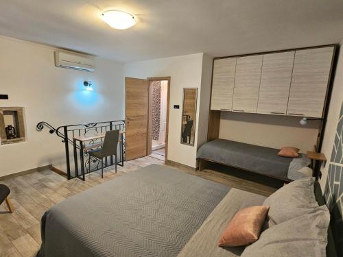 a bedroom with a bed and a table in it at Villa Kos in Lupoglav