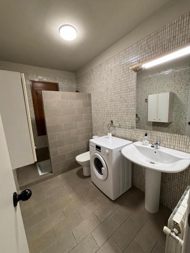 a bathroom with a washing machine and a sink at Casa Ángeles in Beceite