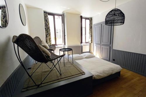 Cette chambre comprend un lit et une chaise. dans l'établissement Annecy Old Town Lake Apartment, à Annecy