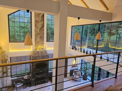 a large room with a balcony with windows at Kesane in Ozurgetʼi