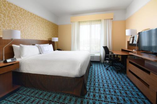 a hotel room with a bed and a television at Fairfield Inn & Suites by Marriott Fort Worth South/Burleson in Burleson