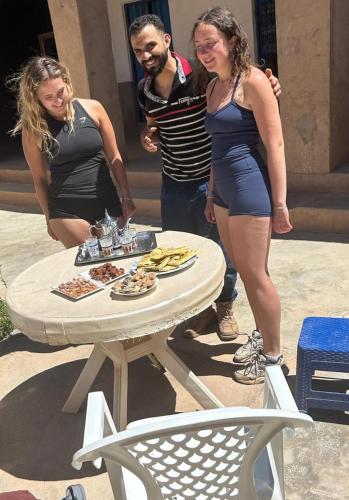 a group of people standing around a table with food at Alliance tradition in Boumalne