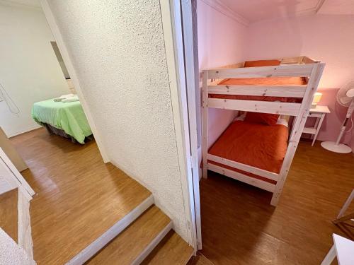 a small room with a bunk bed and a staircase at Ignis Rural Apartment - Casillas Valle de Ayora in Jalance