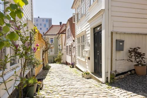 a cobblestone alley in a city with buildings at Welcome to our home in the centre of Bergen! in Bergen