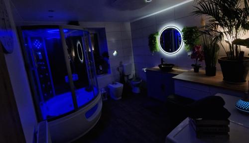 a blue bathroom with a shower and a sink at Ferienhaus Mefady Jünkerath in Jünkerath