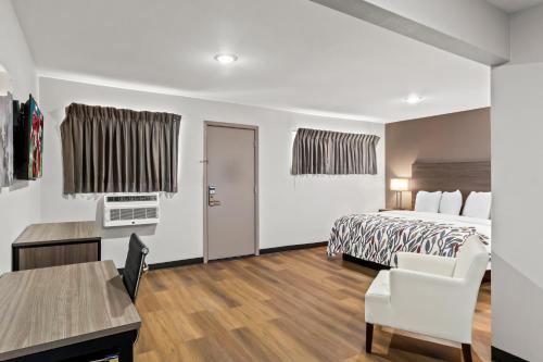 a hotel room with a bed and a desk at Red Roof Inn Del Rio in Del Rio