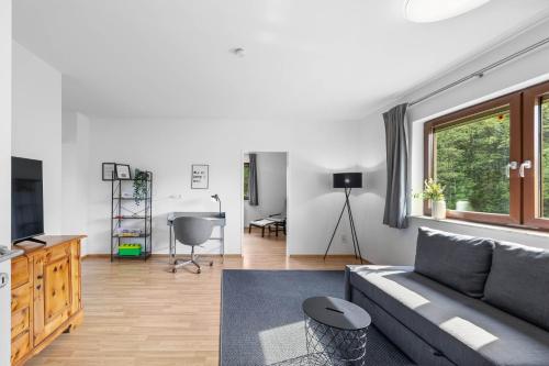 a living room with a couch and a table at NA-Home Melcherhof in Grafenstein