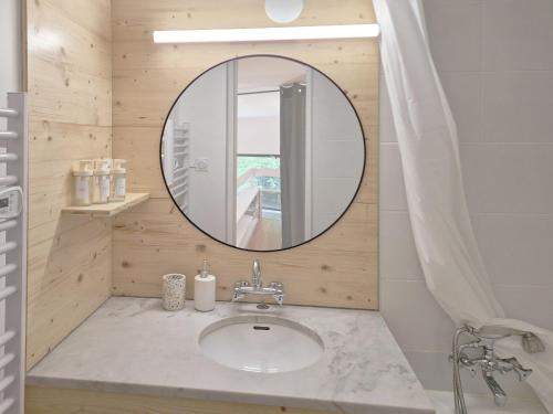 une salle de bain avec un lavabo et un miroir dans l'établissement Argentiere Duplex Apartment, à Chamonix-Mont-Blanc