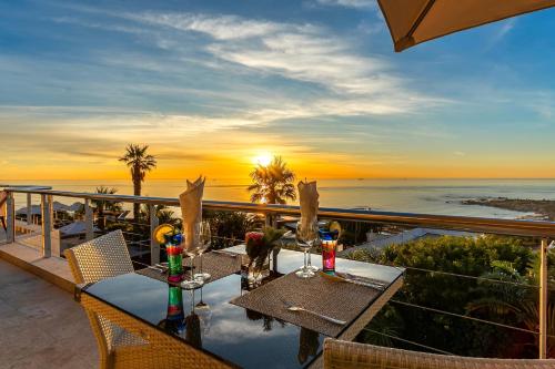 a table on a balcony with a view of the ocean at Atlanticview Cape Town Boutique Hotel in Cape Town