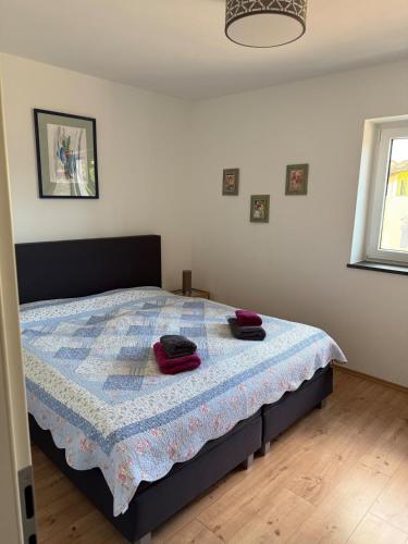 a bedroom with a bed with red towels on it at Three-castle-view in a new appartment in Neckarsteinach