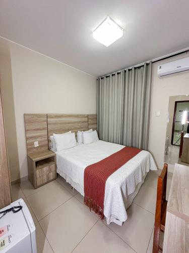 Ένα ή περισσότερα κρεβάτια σε δωμάτιο στο Hotel Tropical Paracatu Ereli