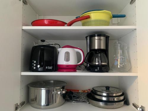un placard rempli de nombreux ustensiles de cuisine dans l'établissement Nice studio close to the sea, à Nice