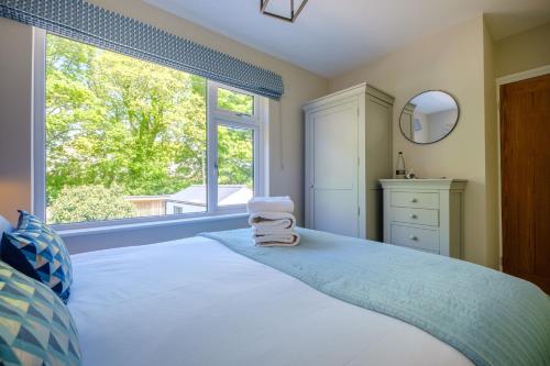 a bedroom with a bed and a large window at The Bank House in Silverdale