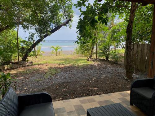 a view of the beach from a porch with chairs at Casa Blanca Cambutal in Cambutal