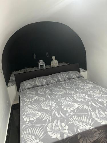 a bedroom with a large bed with a black headboard at i girasoli appartament s in Bari