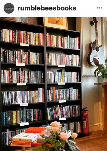 a book shelf filled with lots of books at Upstairs at Rumblebees in Felsted Station
