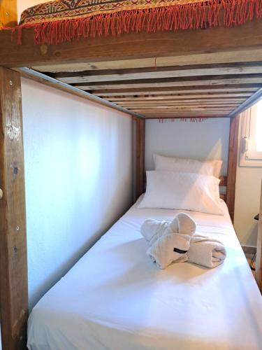 a white bed with a towel on top of it at Evilion- Potidaia- Halkidiki- 100m from the sea in Nea Potidaea