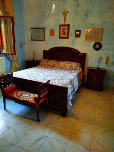 a bedroom with a large bed and a chair at MarGaMik Holiday in Aradeo