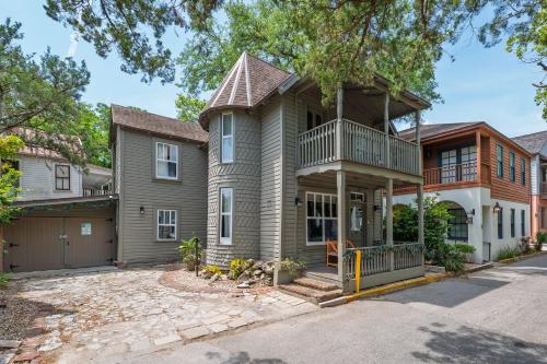 a house with a balcony on a street at Urban Loft - City Center Walk to Everything in Saint Augustine