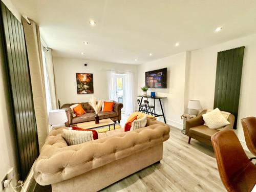 a living room with a couch and two chairs at Brecon beacons Cottage with Cinema Room sleeps 5 in Pont Sticill