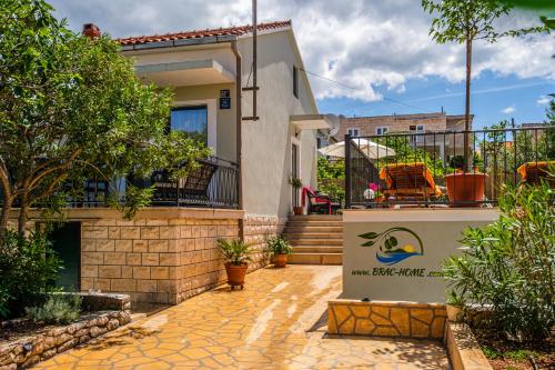 a house with a sign in front of it at Holiday Home Josipa in Supetar