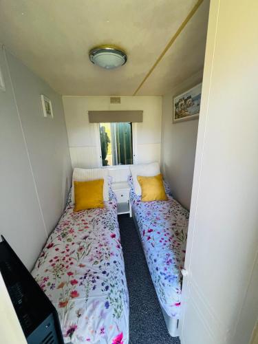 a room with two beds in a small room at Ramshaw View in Leek