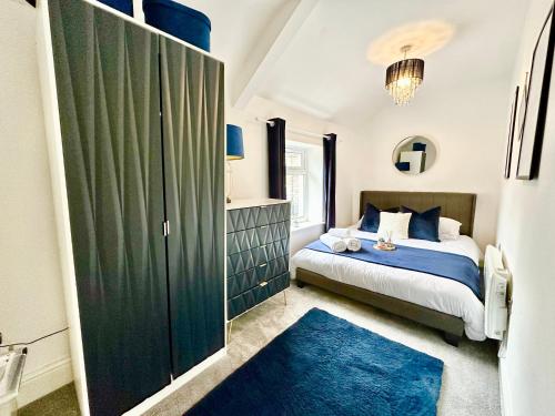 ein Schlafzimmer mit einem Bett und einem großen grünen Schrank in der Unterkunft Brecon beacons Cottage with Cinema Room sleeps 5 in Pont Sticill