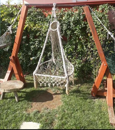 a basket swing and a chair in a yard at DEFNE OTEL in Sile