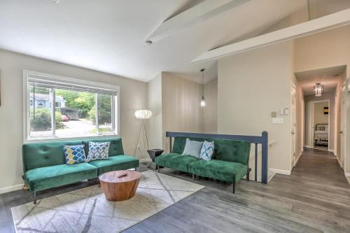 a living room with two green couches and a window at Creek Front Pocono Mountain Getaway with Game room & Sauna in Tobyhanna
