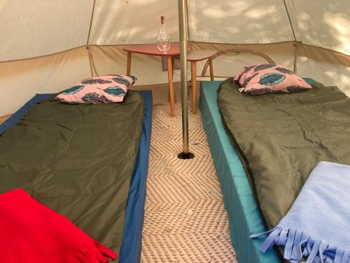 - 2 lits dans une tente avec une table dans l'établissement Nid perché à Bayonne, à Bayonne