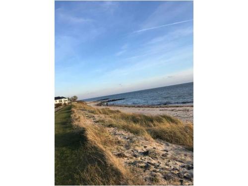 a sandy beach with the ocean in the background at Island Nest Modern Retreat in Fehmarn