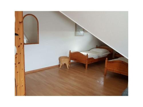 a room with a bed and a mirror and stairs at Island Nest Modern Retreat in Fehmarn