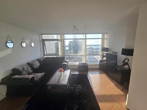 a living room with a couch and a table at Ventro Apartments LIVERPOOL in Liverpool