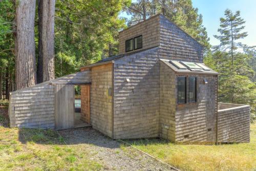 a small brick house in the middle of a field at Architectural Treasure - Private Hot Tub in Sea Ranch