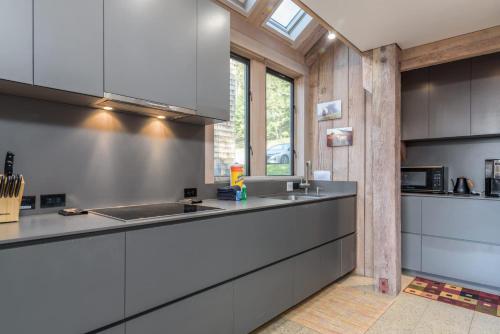 a kitchen with stainless steel counters and a sink at Architectural Treasure - Private Hot Tub in Sea Ranch