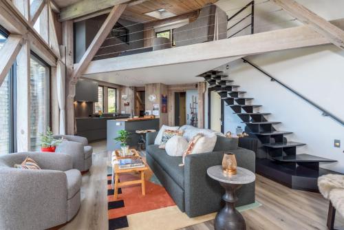 a living room with a staircase in a house at Architectural Treasure - Private Hot Tub in Sea Ranch