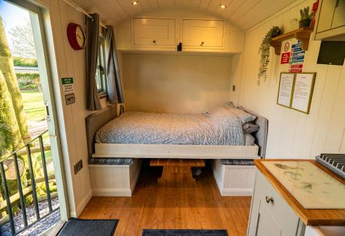 a bedroom in a tiny house with a bed in it at Lavender Retreat with Private Hot Tub in Upper Hulme