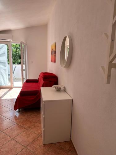 a room with a bed and a table with a mirror at Apartmani Šehović in Borovići