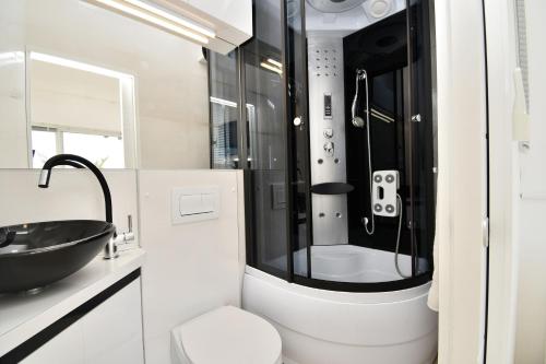 a bathroom with a black sink and a toilet at House Luxury in Matulji