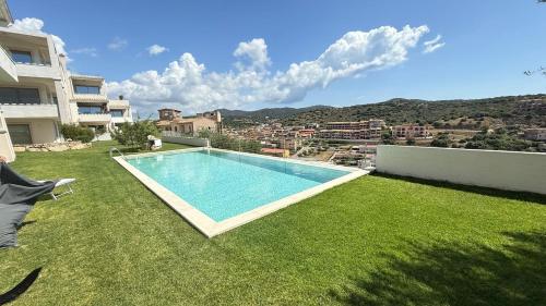 a swimming pool in the yard of a house at Domu sa luna mia in Villasimius